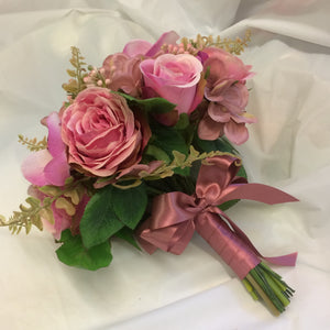 A wedding bouquet colllection of dusky pink roses, hydrangea and orchids
