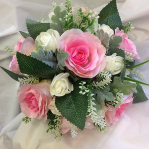 A wedding bouquet of pink artificial silk rose flowers
