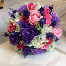 A brides wedding bouquet of artificial pink & purple flowers