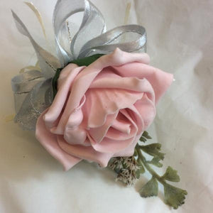 a pale pink rose buttonhole and silver grey foliage
