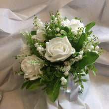 a wedding bouquet collection of white or ivory roses & lily of the valley