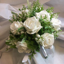 a wedding bouquet collection of white or ivory roses & lily of the valley