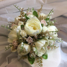 a brides bouquet of artificial silk ivory and dusky pink peony & roses
