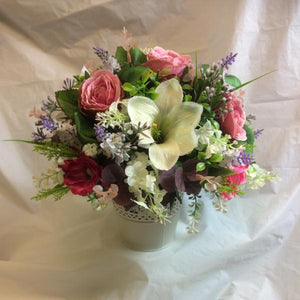artificial flower arrangement in shades of pink and ivory