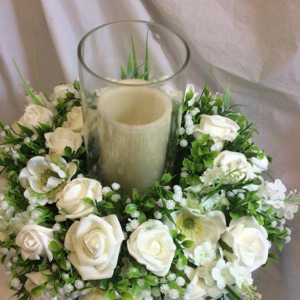 a table centre wreath of ivory artificial flowers