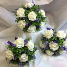 A wedding bouquet collection of artificial ivory & lavender flowers
