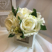 an ivory flower arrangement in cream shabby chic wooden box