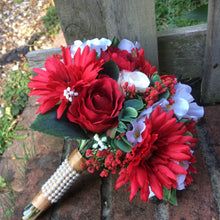a brides wedding bouquet of artificial silk ivory, red & peach flowers