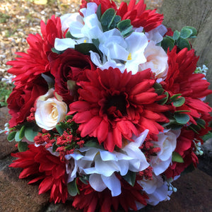 a brides wedding bouquet of artificial silk ivory, red & peach flowers