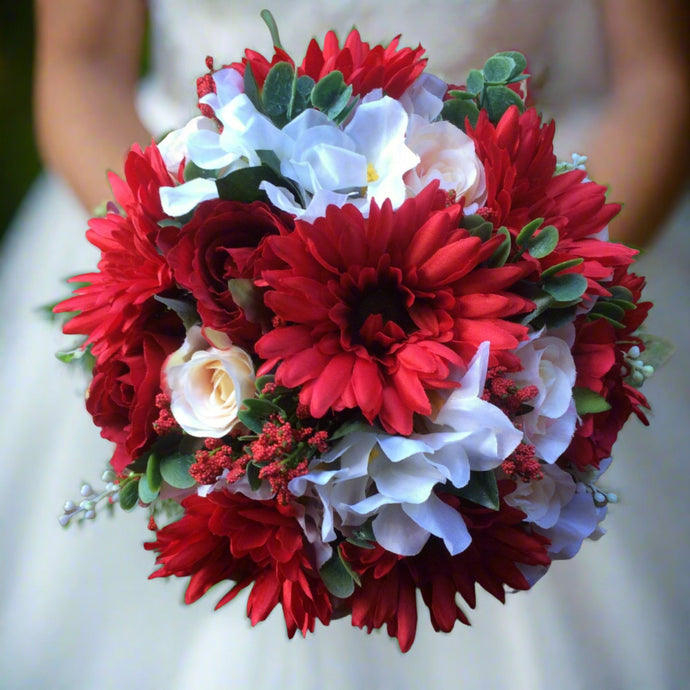 a brides wedding bouquet of artificial silk ivory, red & peach flowers