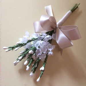 A buttonhole featuring artificial white heather