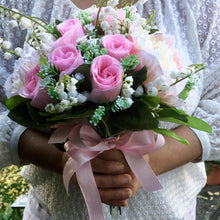 artificial wedding flower bouquet of pink roses, lily of the valley and peonies