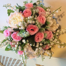artificial wedding flower bouquet of pink roses, lily of the valley and peonies