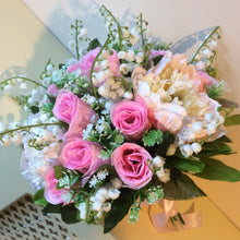 - An artificial wedding bouquet of artificial pink roses, peony & lily of the valley