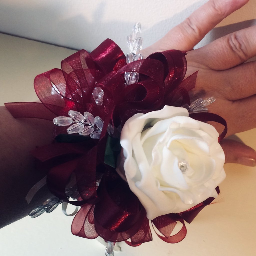 wrist corsage of a single artificial foam rose and crystals