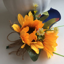 a sunflower corsage with royal blue rose
