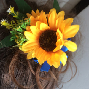 A bridal hair comb featuring yellow sunflowers & royal blue ribbon