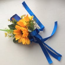 A collection of wedding bouquets featuring  sunflowers and either royal or navy blue roses