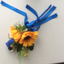A collection of wedding bouquets featuring  sunflowers and either royal or navy blue roses