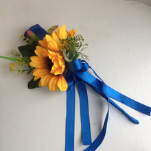 a bridesmaids flower wand of ivory lilac, sunflowers and royal blue rose