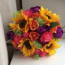 artificial wedding bouquet of purple. orange, yellow and hot pink flowers