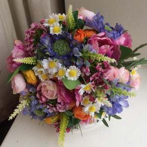 A brides bouquet of multi coloured cottage garden type flowers