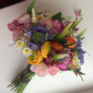 A brides bouquet of multi coloured cottage garden type flowers