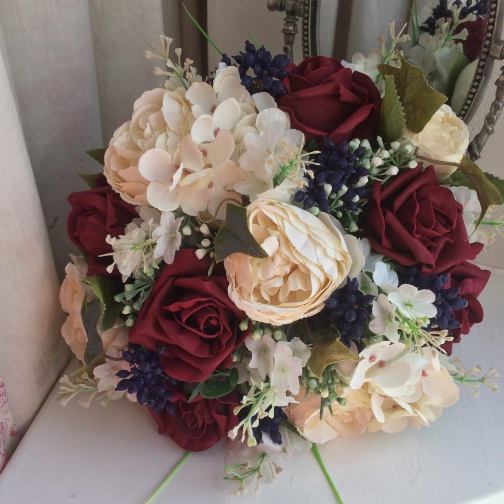 artificial wedding bouquet of burgundy and ivory flowers