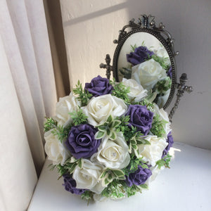 A wedding bouquet of artificial ivory and purple roses