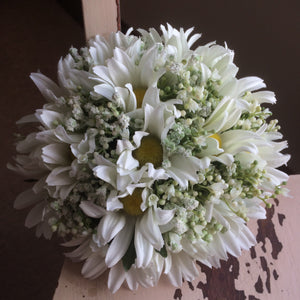 a wedding bouquet of artificial daisies and gyp