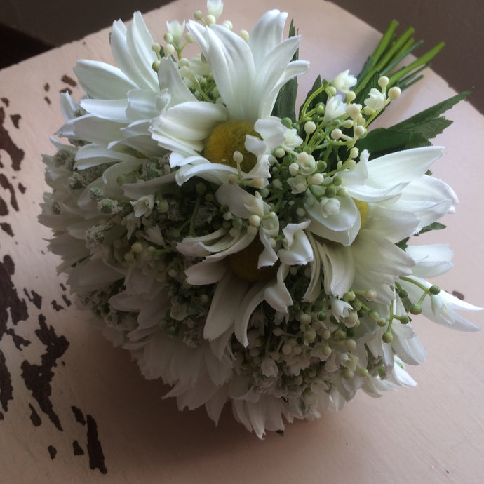 a wedding bouquet of white daisies and gypsophila