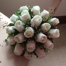 A bridal bouquet featuring artificial silk white roses and gyp