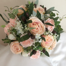 a bouquet of blush roses and olive foliage