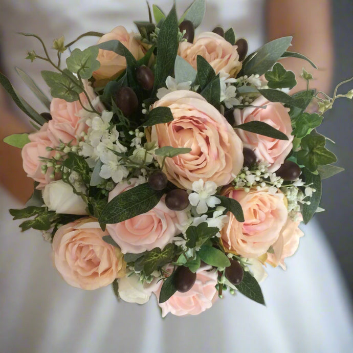 a bouquet of blush roses and olive foliage