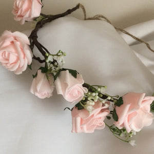 a flower crown of pale pink artificial rose flowers