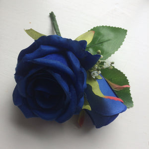 a pin on corsage of silk roses