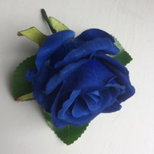 a buttonhole featuring a single silk rose (different colours available)