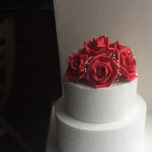 an arrangement of roses for the top of the cake