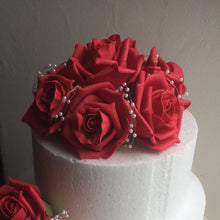 a cake topper featuring artificial foam roses (choice of colours)