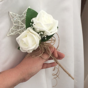 artificial ivory roses and twine decorate this metal ivory star wand