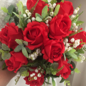 A wedding bouquet and buttonhole collection of artificial roses