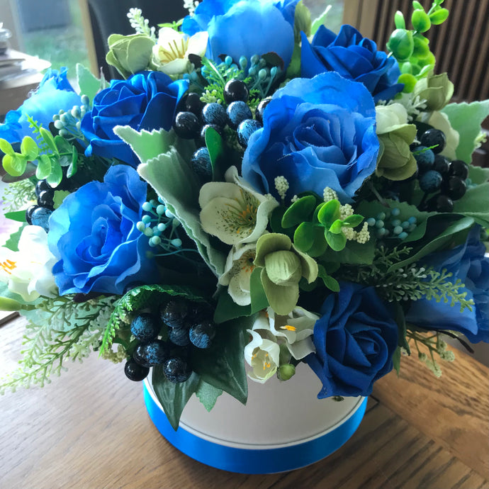 blue artificial flowers in hat box