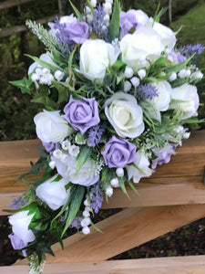 A teardrop bouquet collection of ivory and lilac artificial roses