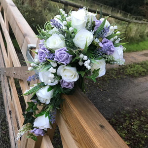 A teardrop bouquet collection of ivory and lilac artificial roses