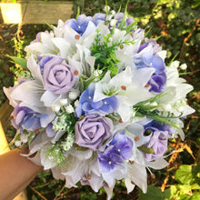 artificial bouquet of blue and lilac flowers