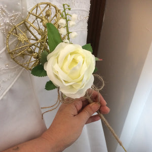 A bridesmaids gold metal heart shaped wand with hessian handle