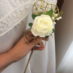 A bridesmaids gold metal heart shaped wand with hessian handle