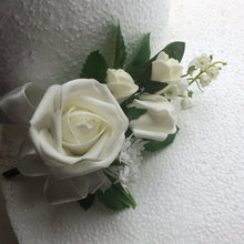 a corsage of ivory foam roses