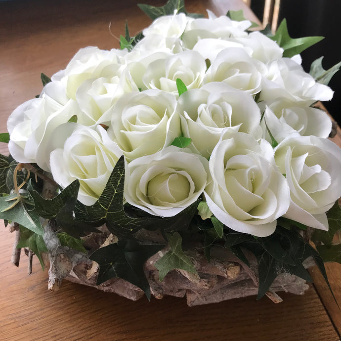 a flower arrangement of ivory roses