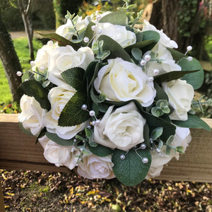 A teardrop wedding bouquet collection of artificial ivory roses